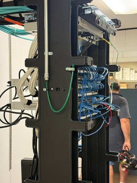Commercial electrician installing network cabling and electrical equipment in an Elkton, MD facility