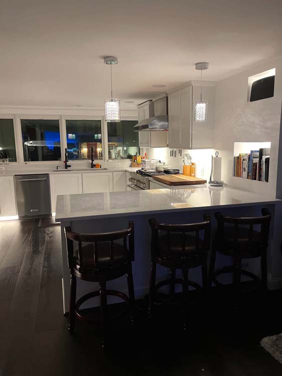 Residential electrician installing wiring and fixtures during a home renovation project in Baltimore County, Maryland